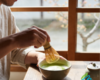 Man whisking matcha tea in a bowl